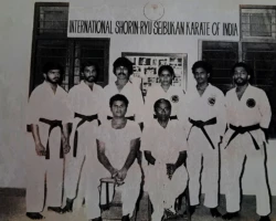 In 1981, a few senior Karatekas came together for a group photo with Sensei P. Kuppusamy (seated left) and the Mayor of Kochi, Mr. A.K. Sheshadri. Standing from left to right are Dr. Prakash Chandran, Prakashan, A.R. Gopi, Mallika, Gandharvan, and myself. Senior Karatekas with Sensei Kuppusamy