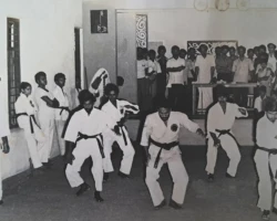 In 1982, in Cochin, Kerala, India, I joined senior Karatekas in demonstrating the Saisan Kata - an ancient karate form often regarded as a gateway to advanced techniques. I am positioned at the center-front of the group. senior Karatekas