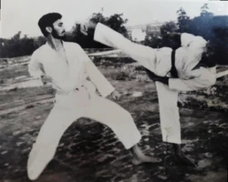 In 1980, I regularly practiced various kicks including the roundhouse kick, as seen here with D.K. Chauhan at Kurukshetra University. The hostel terrace provided an ideal setting for Karate training, offering both open space and atmosphere for focused practice. Roundhouse kick