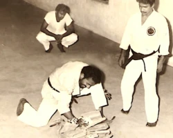 In 1981, during my Shodan (Black Belt) test, I broke ten unsupported tiles as Sensei Kuppusamy and Sensei Raegoo looked on intently. It was a demanding demonstration - a true test of resilience, precision, and unwavering focus. Ranjit breaking unsupported 10 tiles in 1981 as Sensei Kuppusamy and Raegoo watch closely.